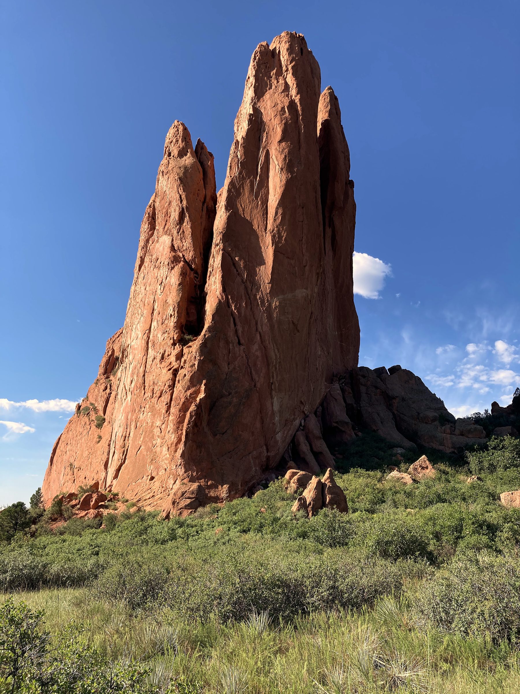 Tall red sandstone spires against bright blue Colorado sky.