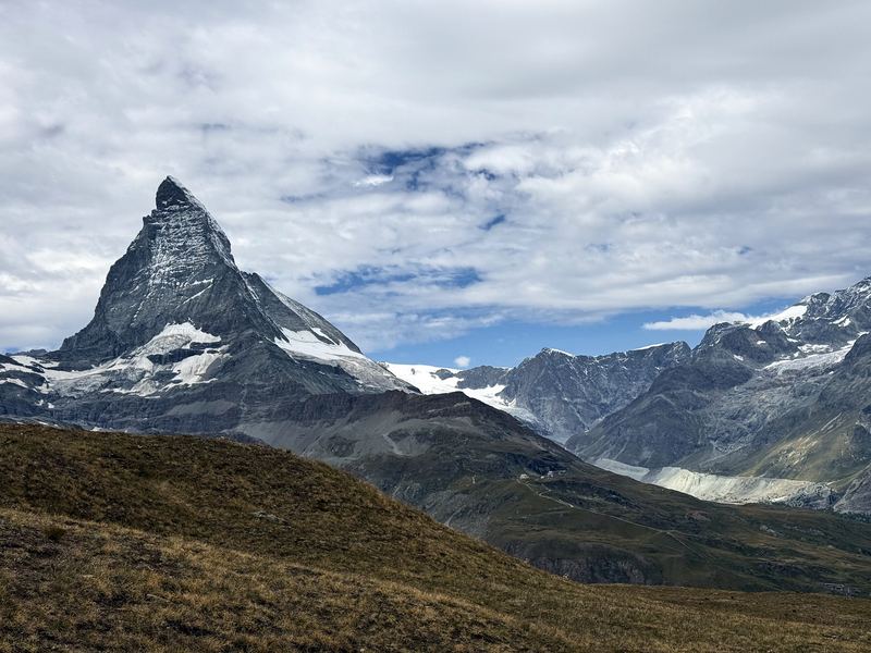 Brown alpine meadow under the clear Matterhorn massif.
